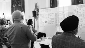Three participants observe the boards during the Vivli Annual Meeting